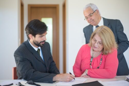 older couple signing divorce papers