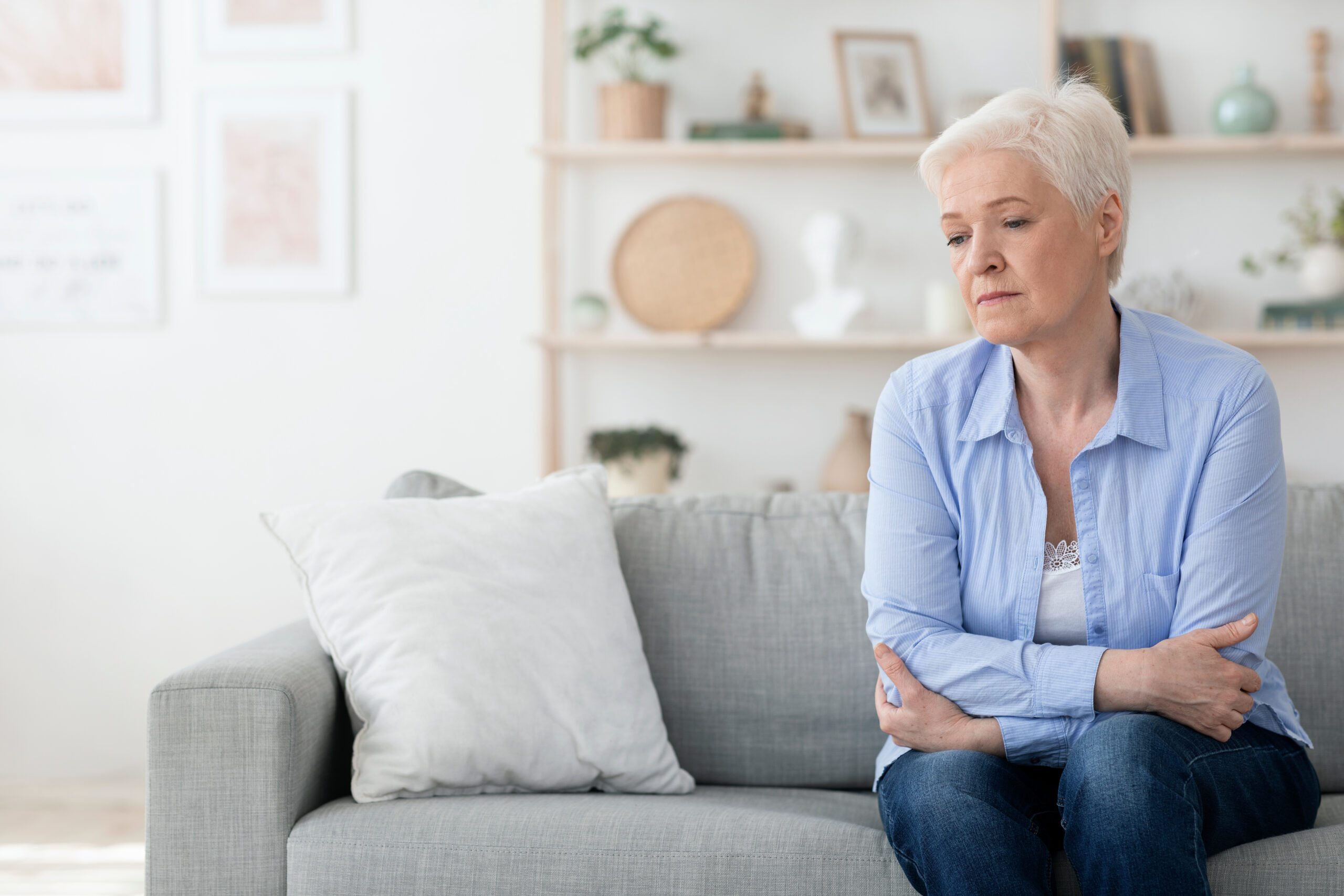 old woman sitting on couch alone