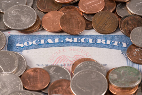 USA social security card overflowing with cash
