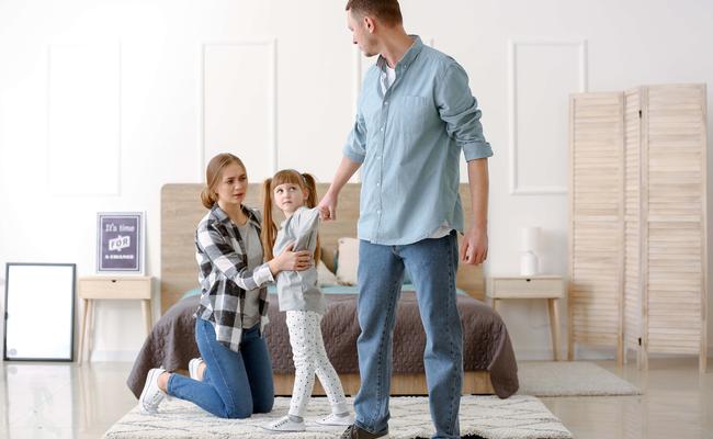 Little girl trying to stop her father from leaving family