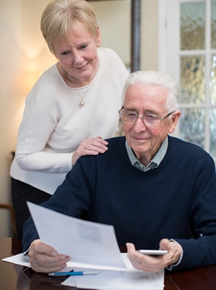 elderly husband and wife look optimistically at estate plan
