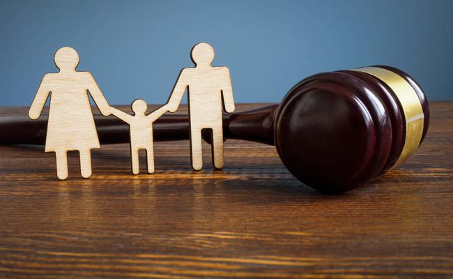 gavel with wooden family figurines