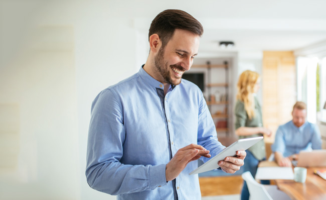 smiling man using tablet