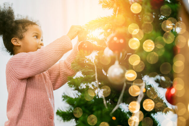 kid arrange decorate christmas tree with fun and cheerful christmas festive ideas concept