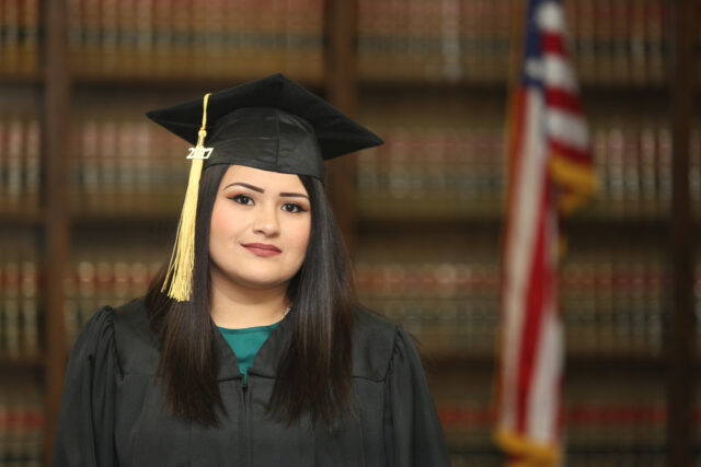 Graduation portrait, young attractive Mexican American college graduate